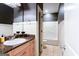Bathroom featuring a granite countertop, modern sink, and a view into the shower and toilet area at 430 Gregory Rd, Covington, GA 30014