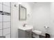 Modern half bathroom with black and white tile and white vanity at 430 Gregory Rd, Covington, GA 30014