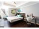 Bright bedroom features a tufted headboard, modern furniture, and hardwood flooring at 430 Gregory Rd, Covington, GA 30014