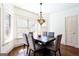 Cozy dining room with large windows, modern lighting, and hardwood floors at 430 Gregory Rd, Covington, GA 30014