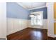 Dining room featuring hardwood floors, wainscoting, and a large window with natural light at 430 Gregory Rd, Covington, GA 30014