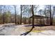 Picturesque driveway meandering through a forest, showcasing the natural beauty of the property at 430 Gregory Rd, Covington, GA 30014