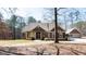 Charming home boasts a stone and cedar exterior, complemented by a matching detached garage at 430 Gregory Rd, Covington, GA 30014