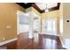 Elegant foyer features hardwood floors, wainscoting, dark stained wood beam ceiling, and glass paneled doors at 430 Gregory Rd, Covington, GA 30014