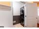 Stackable black washer and dryer offer convenience in this laundry room at 430 Gregory Rd, Covington, GA 30014