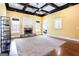 Bright living room with stone fireplace, coffered ceiling, large carpet and gleaming hardwood floors at 430 Gregory Rd, Covington, GA 30014