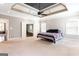 Spacious main bedroom with tray ceiling, ceiling fan, and ensuite bathroom with tub and shower at 430 Gregory Rd, Covington, GA 30014