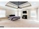 Spacious main bedroom featuring a fireplace, mantel with a TV, and ample natural light from multiple windows at 430 Gregory Rd, Covington, GA 30014