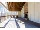 Inviting outdoor deck with a stone fireplace, a built-in kitchen area, and a wood ceiling at 430 Gregory Rd, Covington, GA 30014
