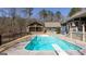 Backyard pool and patio area with a diving board, with an outdoor kitchen at 430 Gregory Rd, Covington, GA 30014
