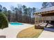 Outdoor pool area featuring a gazebo with a built-in kitchen area and a wrought iron fence at 430 Gregory Rd, Covington, GA 30014