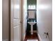 Stylish powder room featuring a pedestal sink, dark green accent wall, and modern lighting fixtures at 430 Gregory Rd, Covington, GA 30014