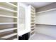 Large walk-in closet featuring built-in shelving, a window seat, and ample storage space at 430 Gregory Rd, Covington, GA 30014