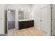 Bright bathroom boasts a double vanity with dark wood cabinets and light wood flooring at 903 Hollytree Pl, Acworth, GA 30102