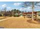 Inviting community area featuring lush landscaping, a charming pergola, and scenic views of the surrounding homes at 903 Hollytree Pl, Acworth, GA 30102
