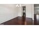 Elegant dining room featuring dark hardwood floors and wainscoting at 903 Hollytree Pl, Acworth, GA 30102