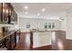 Well-equipped kitchen with granite countertops, dark cabinets and stainless appliances open to living area at 903 Hollytree Pl, Acworth, GA 30102