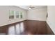 Spacious living room with dark hardwood floors, large windows, and a ceiling fan at 903 Hollytree Pl, Acworth, GA 30102