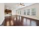 Open living room with dark hardwood floors leading to the kitchen and backyard access at 903 Hollytree Pl, Acworth, GA 30102