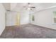 Large bedroom with carpet, tray ceiling, two windows, and door to bathroom at 903 Hollytree Pl, Acworth, GA 30102