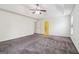 Large bedroom with carpet, tray ceiling, two windows, and door to bathroom at 903 Hollytree Pl, Acworth, GA 30102