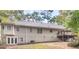 Rear of house with a walkout basement, wooden deck with stairs, and a lush backyard with mature trees at 1300 Lakehaven Pkwy, Mcdonough, GA 30253