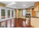 Finished basement with hardwood floors, stainless steel stove, light wood cabinets, and doors leading outside at 1300 Lakehaven Pkwy, Mcdonough, GA 30253