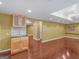 Finished basement features a bar with light wood cabinets, tile backsplash, and lots of open space at 1300 Lakehaven Pkwy, Mcdonough, GA 30253