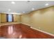 Versatile basement area with hardwood floors and ample lighting at 1300 Lakehaven Pkwy, Mcdonough, GA 30253