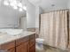 Inviting bathroom with a granite vanity and bamboo shower curtain at 1300 Lakehaven Pkwy, Mcdonough, GA 30253