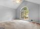 Bright bedroom featuring a large arched window and vaulted ceilings at 1300 Lakehaven Pkwy, Mcdonough, GA 30253