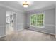 Well-lit dining room with a large window overlooking the backyard and a view of the kitchen at 1300 Lakehaven Pkwy, Mcdonough, GA 30253