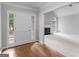 Inviting foyer with hardwood floors, complemented by a bright living space featuring a fireplace and arched window at 1300 Lakehaven Pkwy, Mcdonough, GA 30253