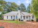 Charming single-story home with a neutral exterior, chimney, multiple windows, and a well-manicured lawn at 1300 Lakehaven Pkwy, Mcdonough, GA 30253