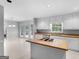 Bright kitchen with island cooktop, white cabinetry, and a view to the breakfast area and outdoor deck at 1300 Lakehaven Pkwy, Mcdonough, GA 30253