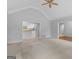 Open-concept living room with neutral carpeting, light gray walls, and view of updated kitchen at 1300 Lakehaven Pkwy, Mcdonough, GA 30253