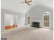 Bright living room featuring a fireplace, neutral carpet, and arched windows for lots of natural light at 1300 Lakehaven Pkwy, Mcdonough, GA 30253