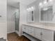 Updated main bathroom with double vanity, wood-look flooring, and glass-enclosed shower at 1300 Lakehaven Pkwy, Mcdonough, GA 30253