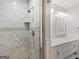 Luxurious bathroom featuring a new shower with marble tile and a double vanity with marble counters at 1300 Lakehaven Pkwy, Mcdonough, GA 30253