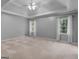 Expansive main bedroom with a tray ceiling and large windows offering lots of natural light at 1300 Lakehaven Pkwy, Mcdonough, GA 30253
