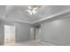Spacious main bedroom with tray ceiling, ceiling fan, and ensuite bathroom at 1300 Lakehaven Pkwy, Mcdonough, GA 30253