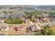 An aerial view showcases houses with mature trees and lush landscaping on a quiet street at 510 Virginia Highlands, Fayetteville, GA 30215