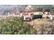 An aerial shot shows a home with red deck surrounded by lush greenery and other neighborhood houses at 510 Virginia Highlands, Fayetteville, GA 30215
