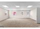 Finished basement showcasing a carpeted area with natural light from windows and a door to the outside at 510 Virginia Highlands, Fayetteville, GA 30215