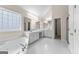 A large bathroom with white cabinets, a soaking tub, tile floors, and double sinks at 510 Virginia Highlands, Fayetteville, GA 30215