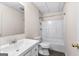 Bathroom featuring a single sink vanity, a toilet, and a shower-tub combo with white tile surround at 510 Virginia Highlands, Fayetteville, GA 30215