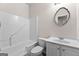Neutral bathroom offers a tub/shower combo, white cabinets, and a decorative mirror at 510 Virginia Highlands, Fayetteville, GA 30215