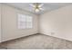 Neutral bedroom features a ceiling fan, window, and neutral carpet at 510 Virginia Highlands, Fayetteville, GA 30215