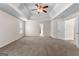 Large carpeted bedroom with neutral walls and ceilings and a ceiling fan with attached lighting at 510 Virginia Highlands, Fayetteville, GA 30215