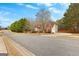 Suburban two-story home on a tree-lined street, featuring a brick facade and attached garage at 510 Virginia Highlands, Fayetteville, GA 30215